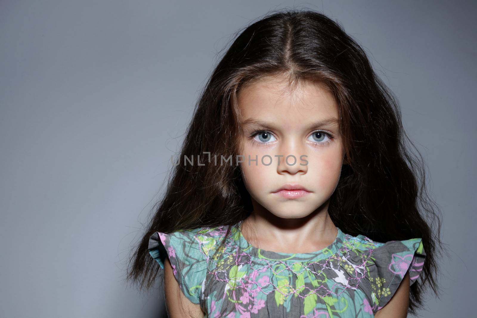 close up portrait of young beautiful little girl with dark hair