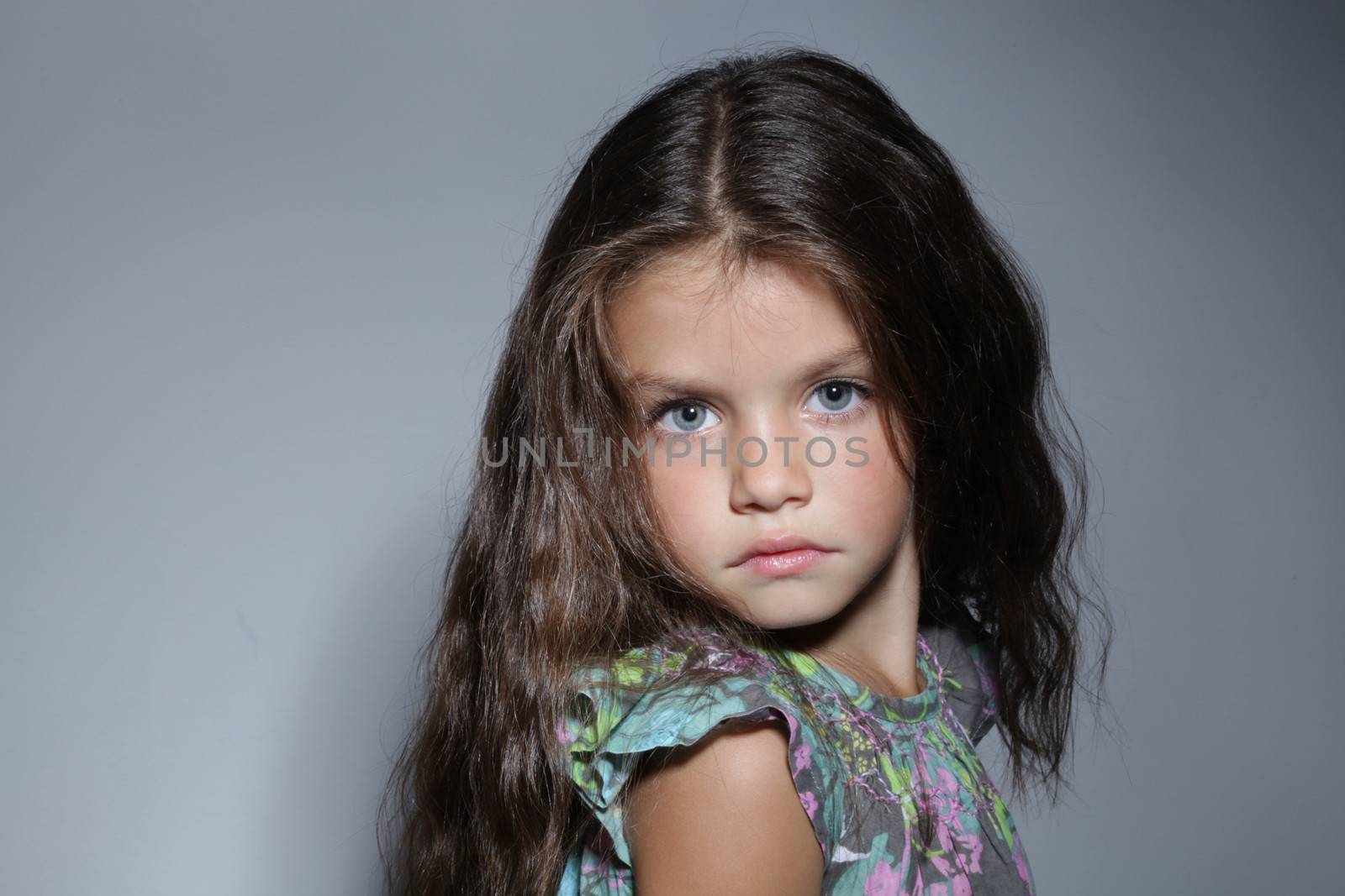 close up portrait of young beautiful little girl with dark hair