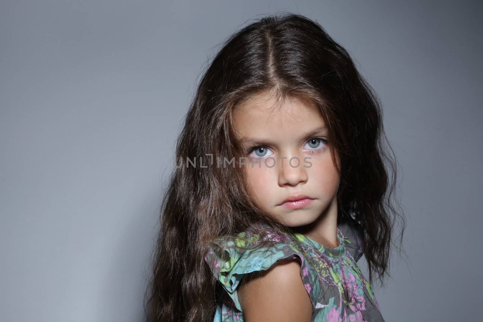 close up portrait of young beautiful little girl with dark hair