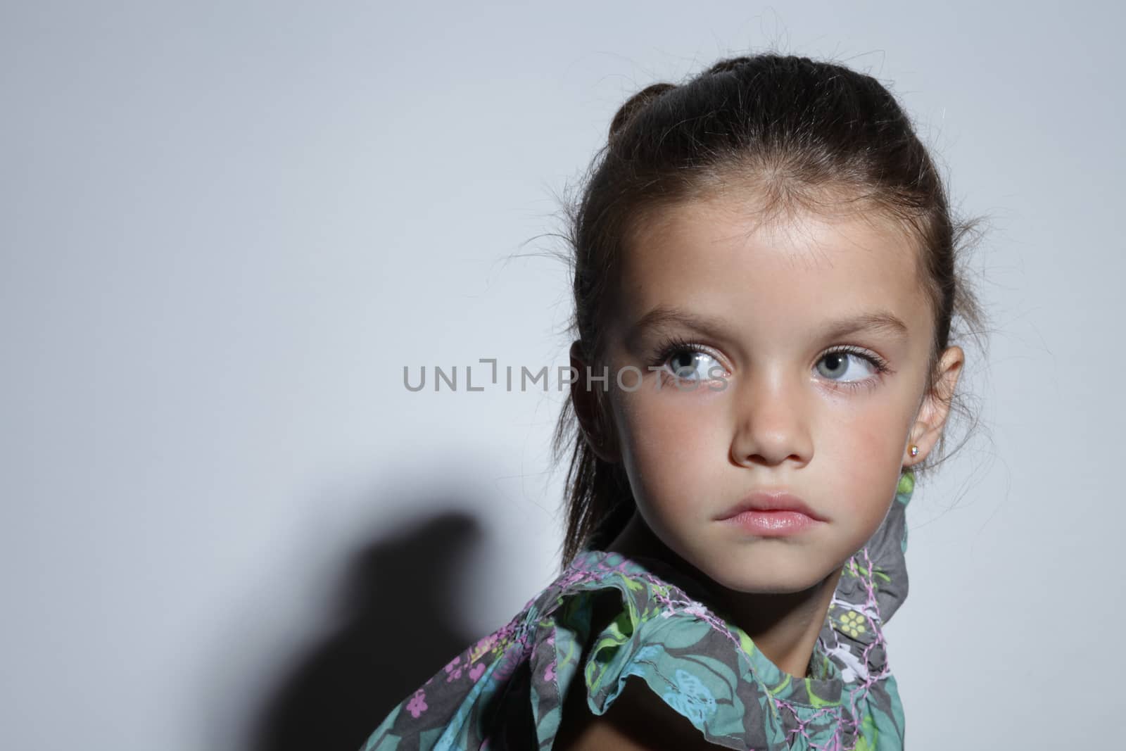 close up portrait of young beautiful little girl with dark hair