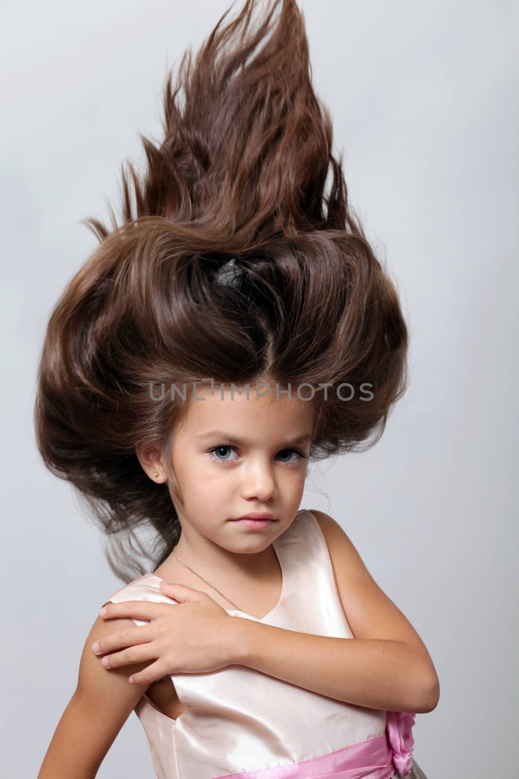 portrait of little girl with extravagant hair on his head