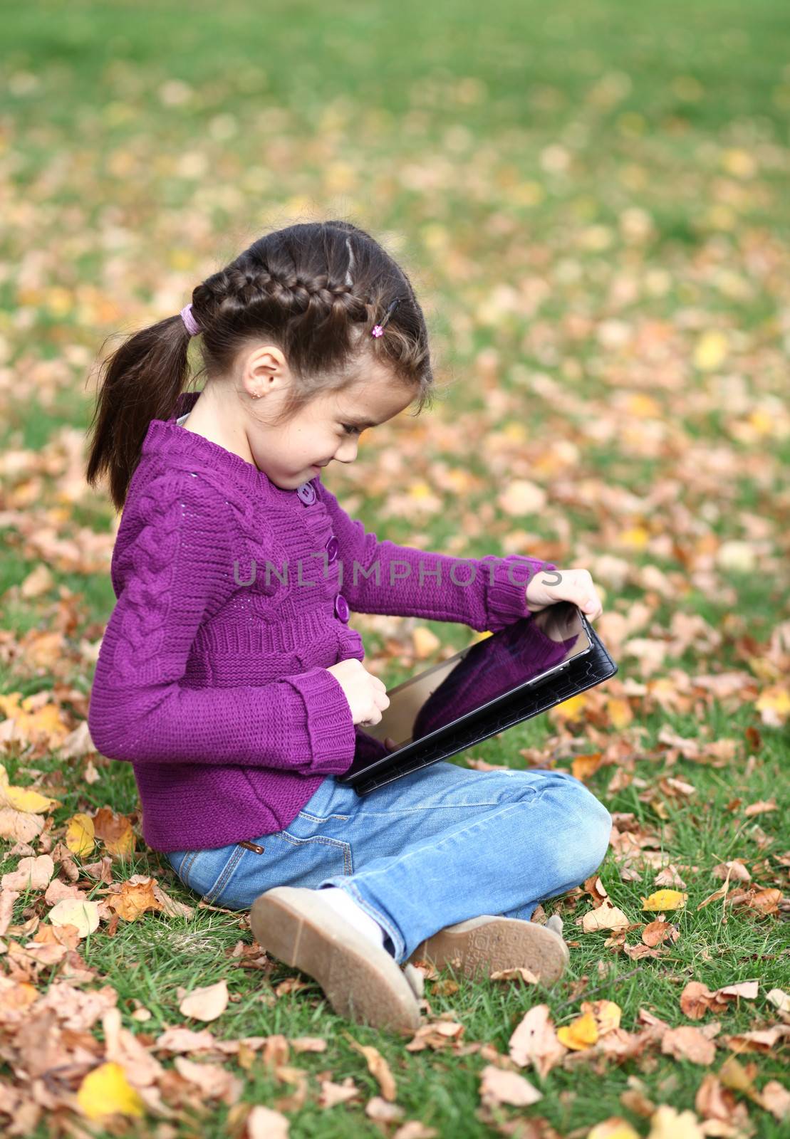 Little Girl holding tablet digital computer by andersonrise