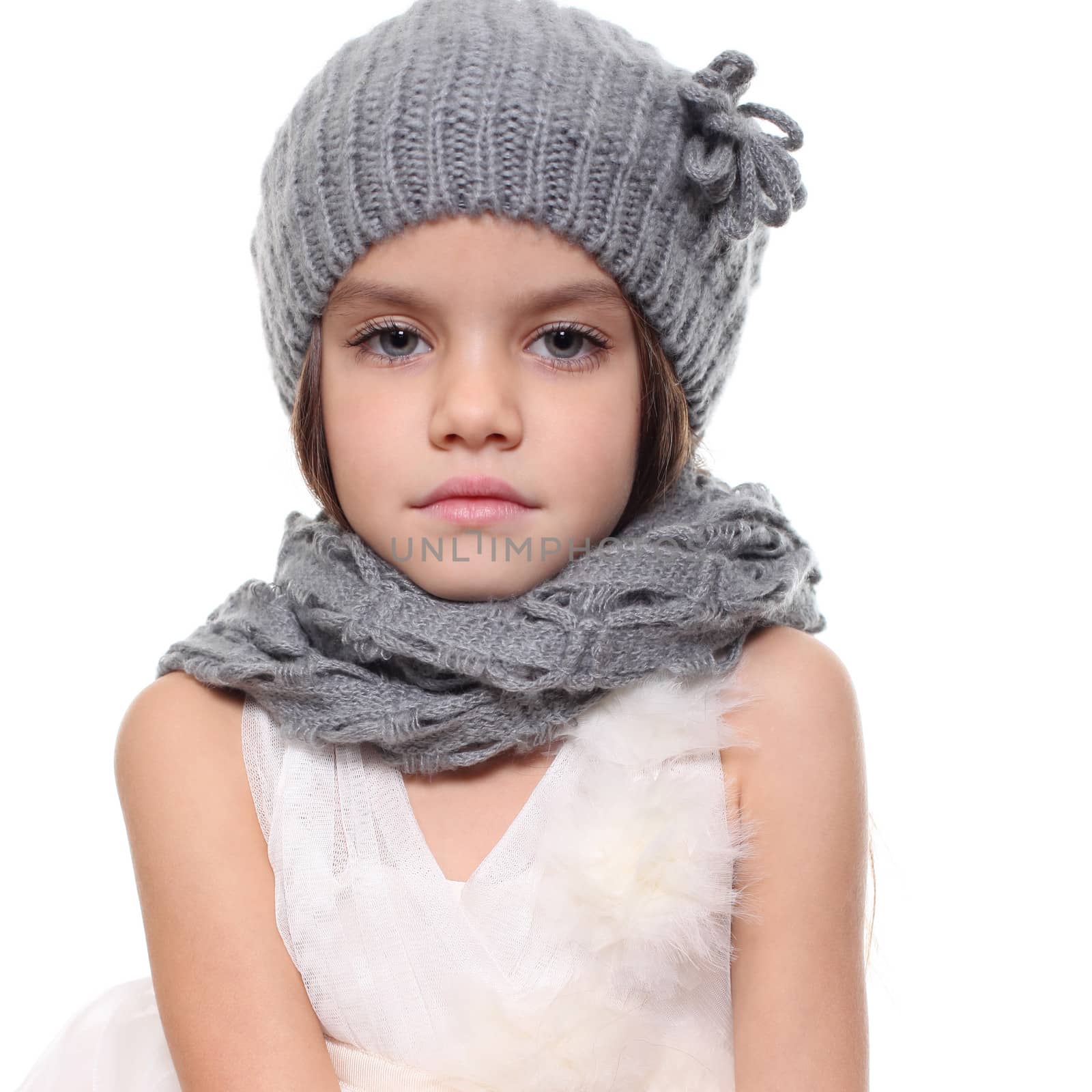 little girl in a knitted hat and gray scarf by andersonrise