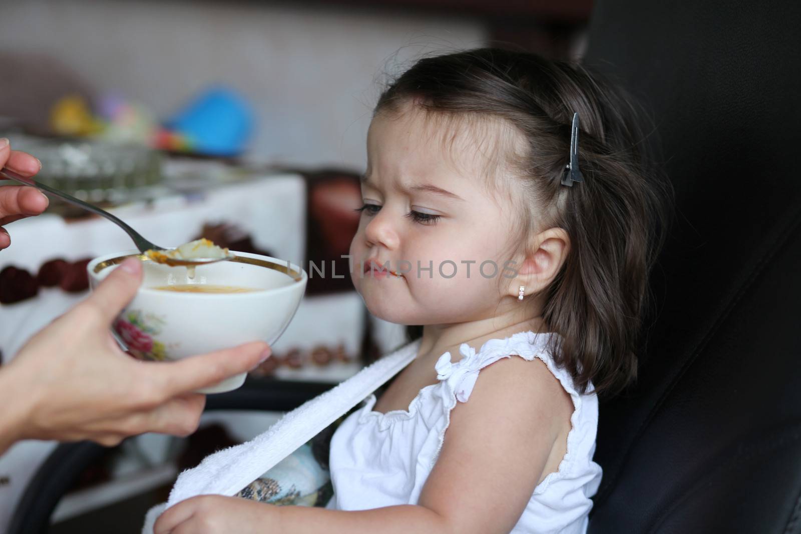 Little baby girl eating soup