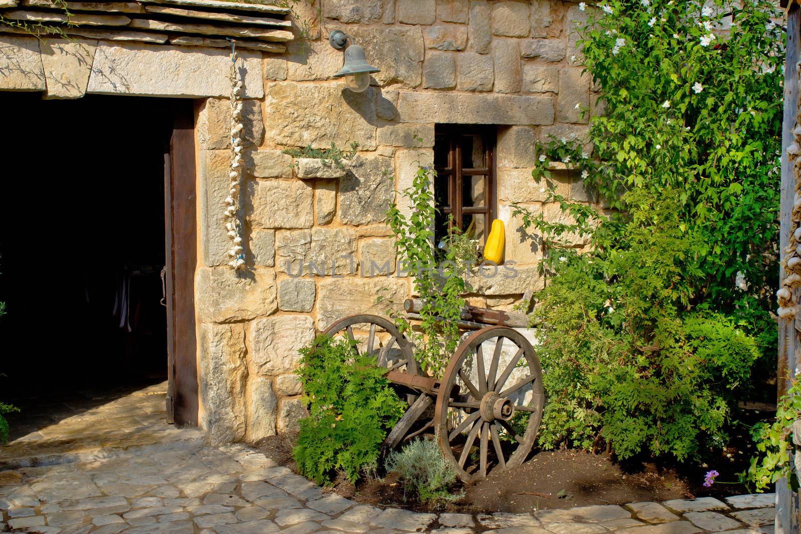 Old rusty plough in stone street of Dalmatian village