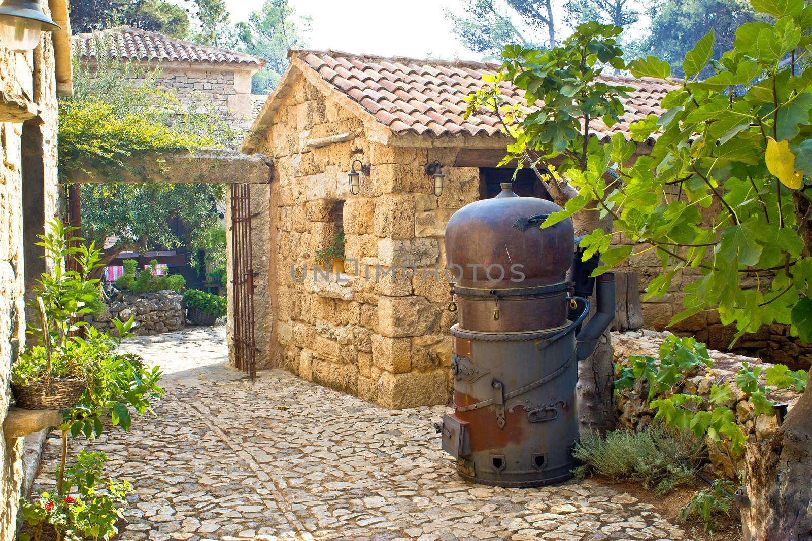 Traditional brandy still in stone village by xbrchx