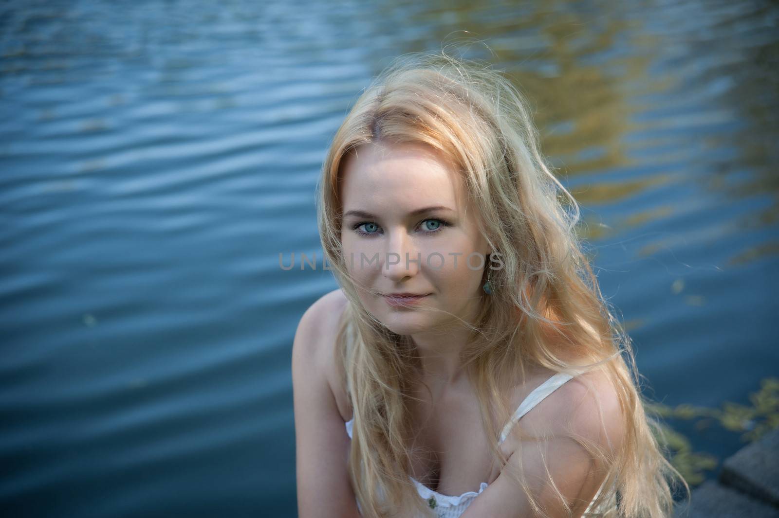 Beautiful young woman on the background of the sea.