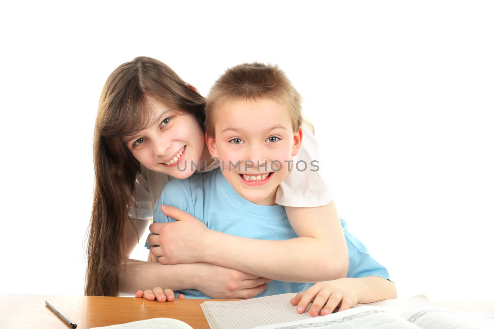 happy brother and sister on the table with exercise books