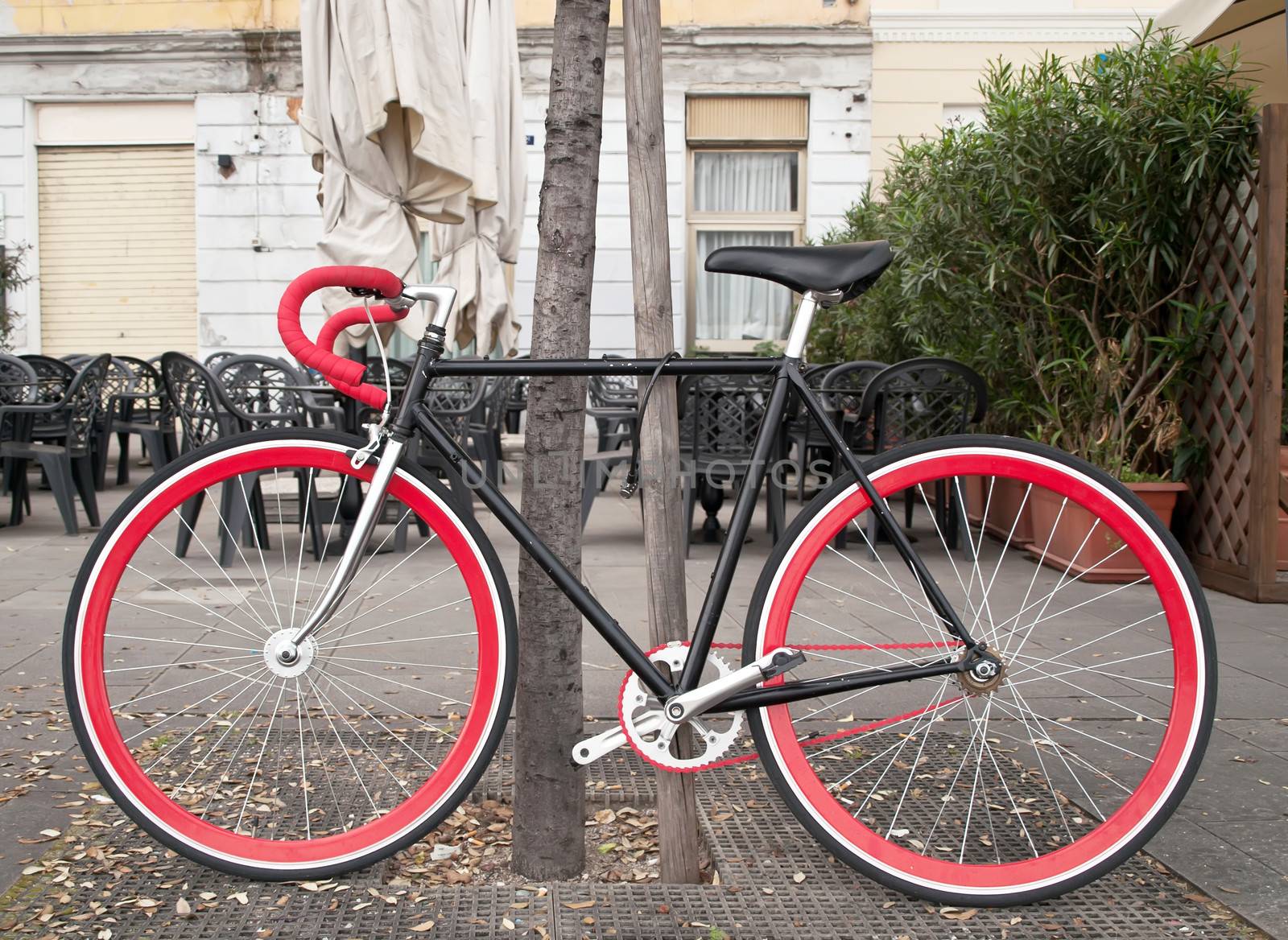 bicycle with red chain locked in the park