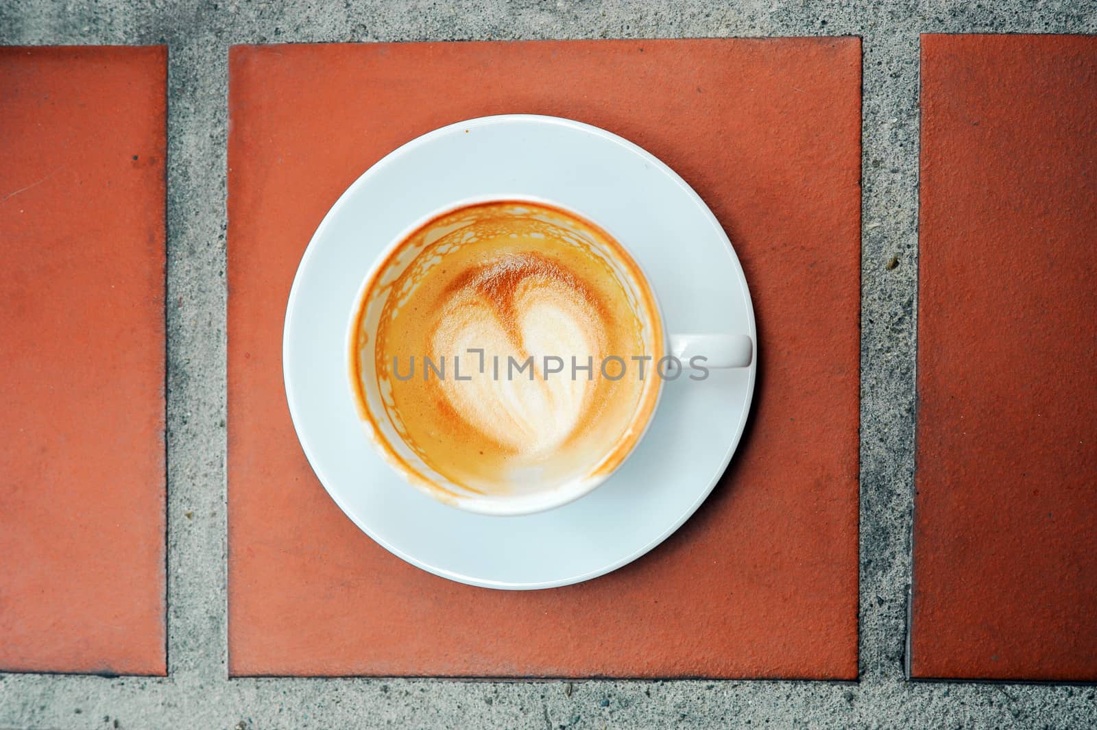 Empty Glass of Coffee on brown floor