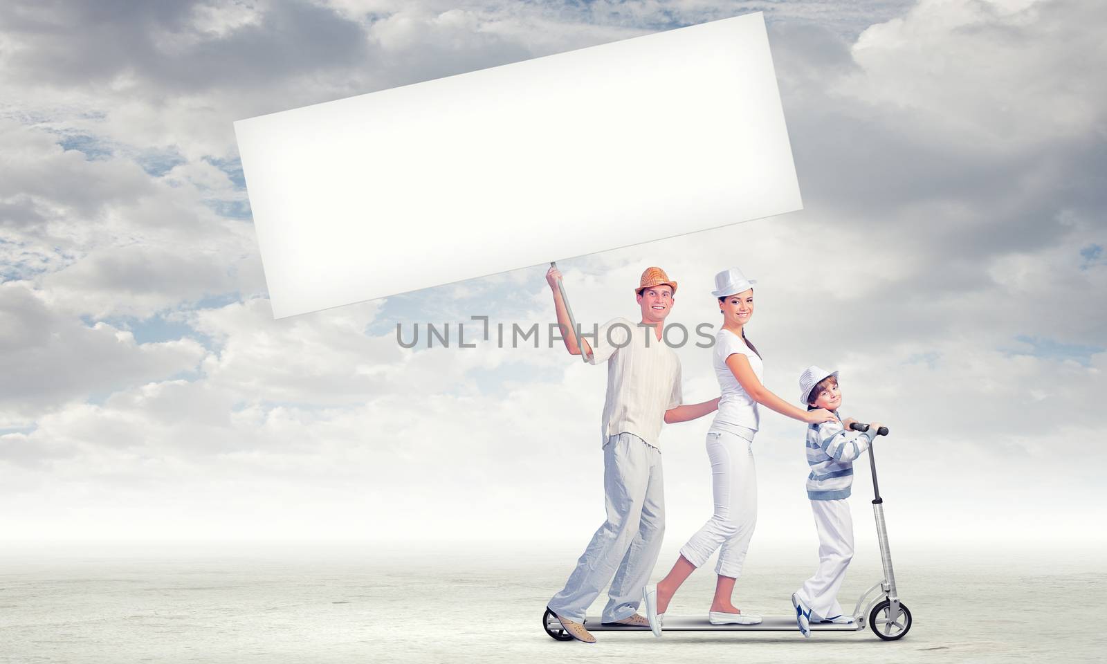Image of happy young family riding on scooter pulling blank banner