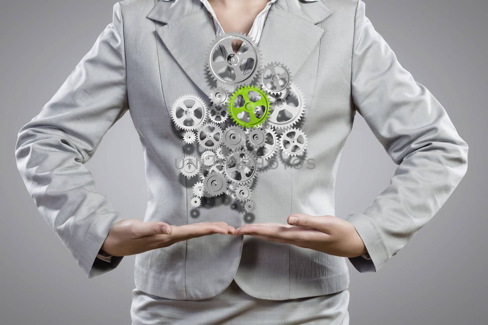 Close up image of businesswoman holding gears in hands