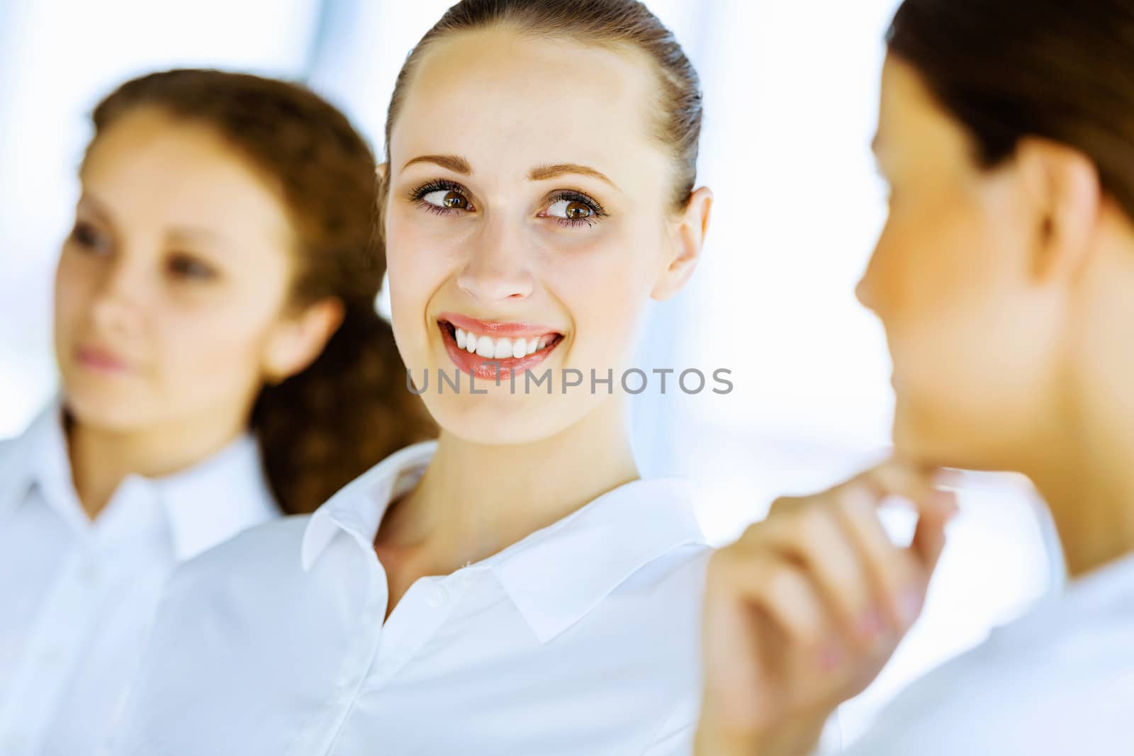 Image of three young businesswomen at meeting