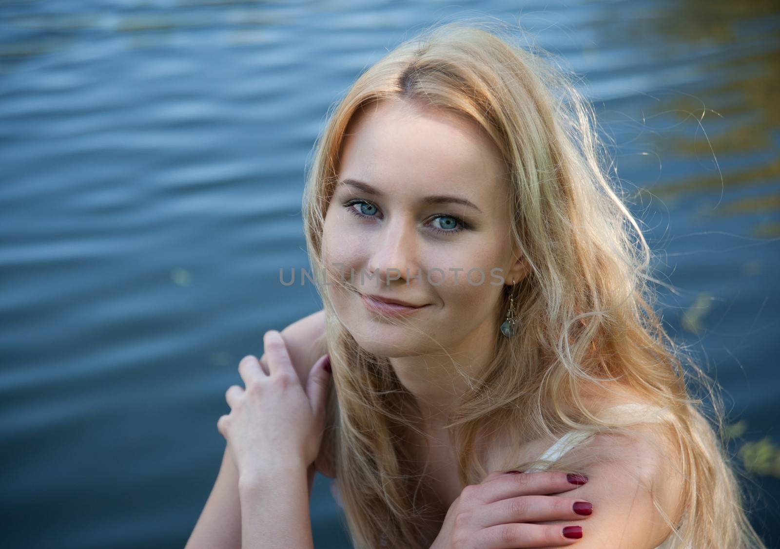 Beautiful young woman on the background of the sea.