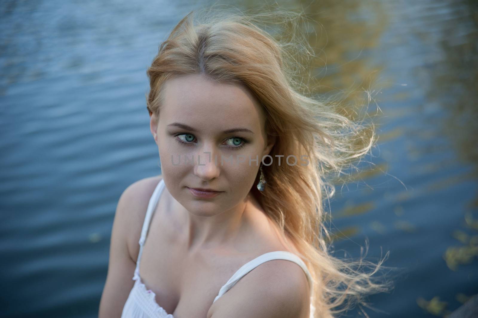 Beautiful young woman on the background of the sea.