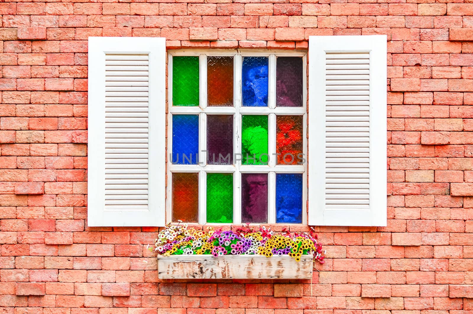 Colorful window on a brick wall.