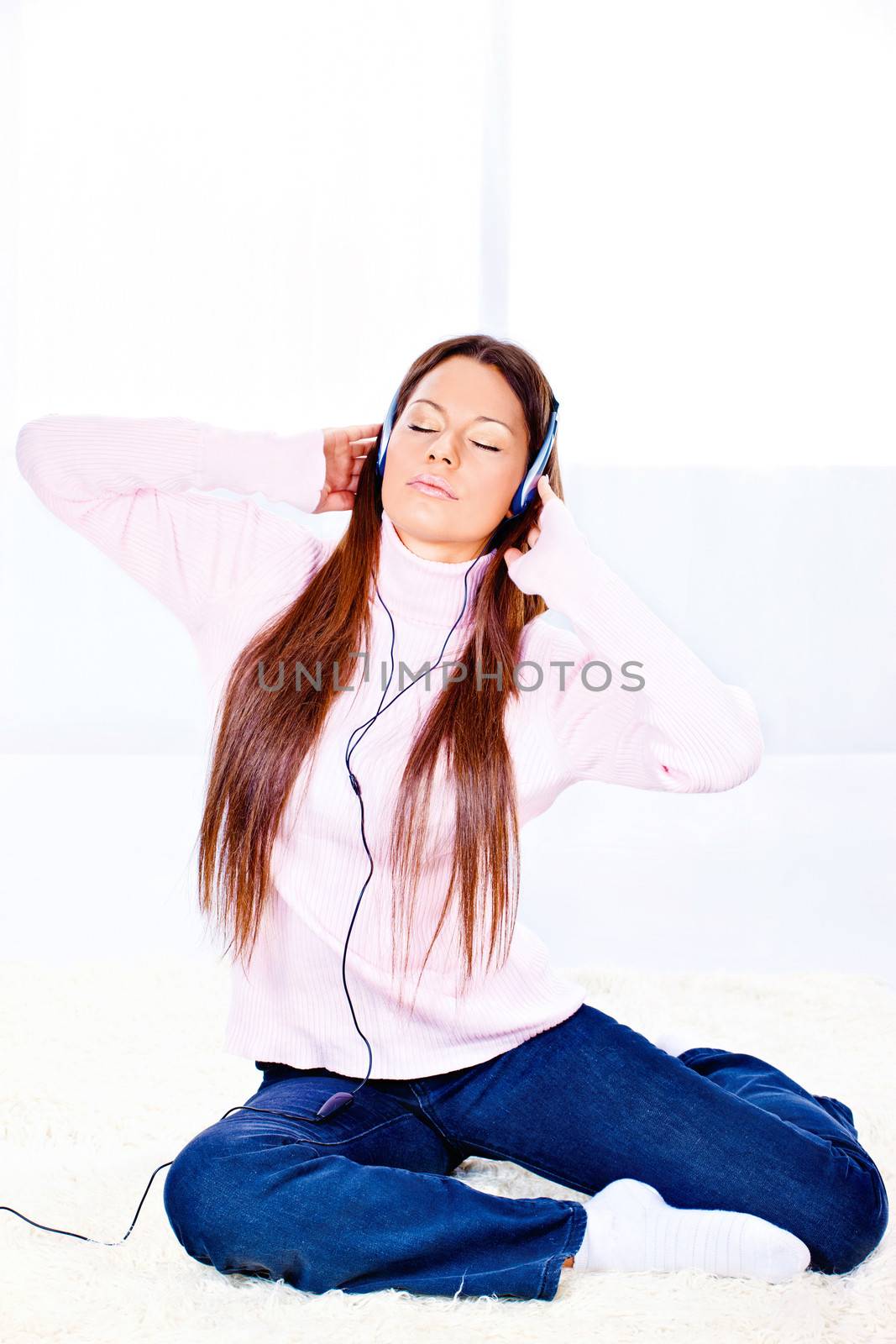 woman with headphones at home by imarin