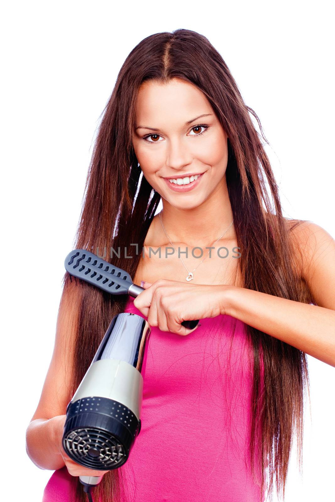 woman with long hair holding blow dryer and comb