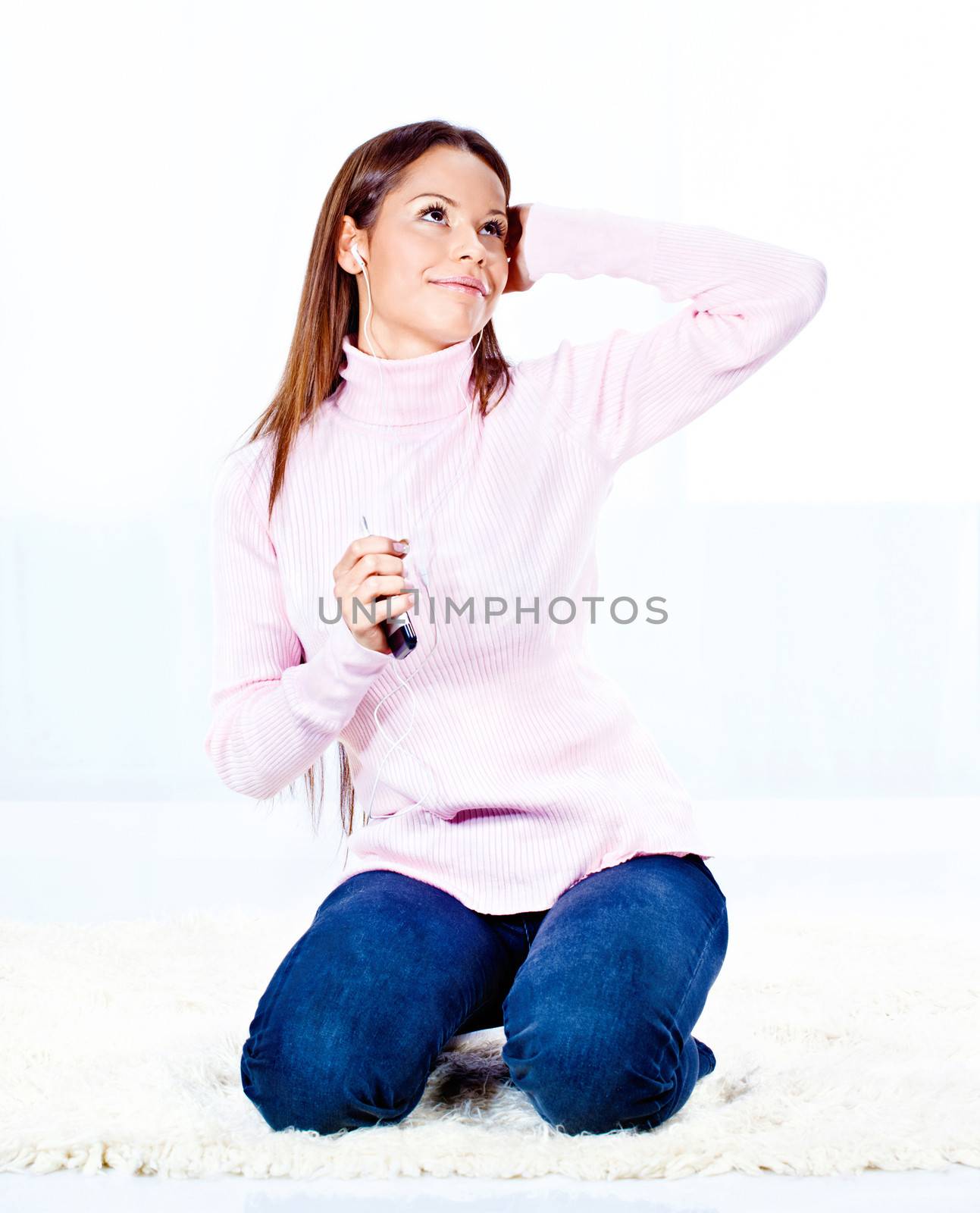 Pretty young woman with headphones listening music at home