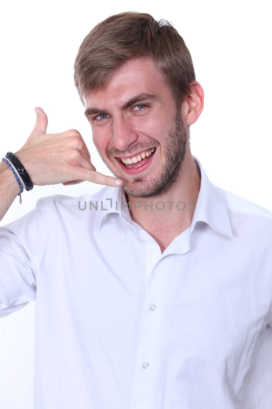 Young man using a call me gesture and a phone