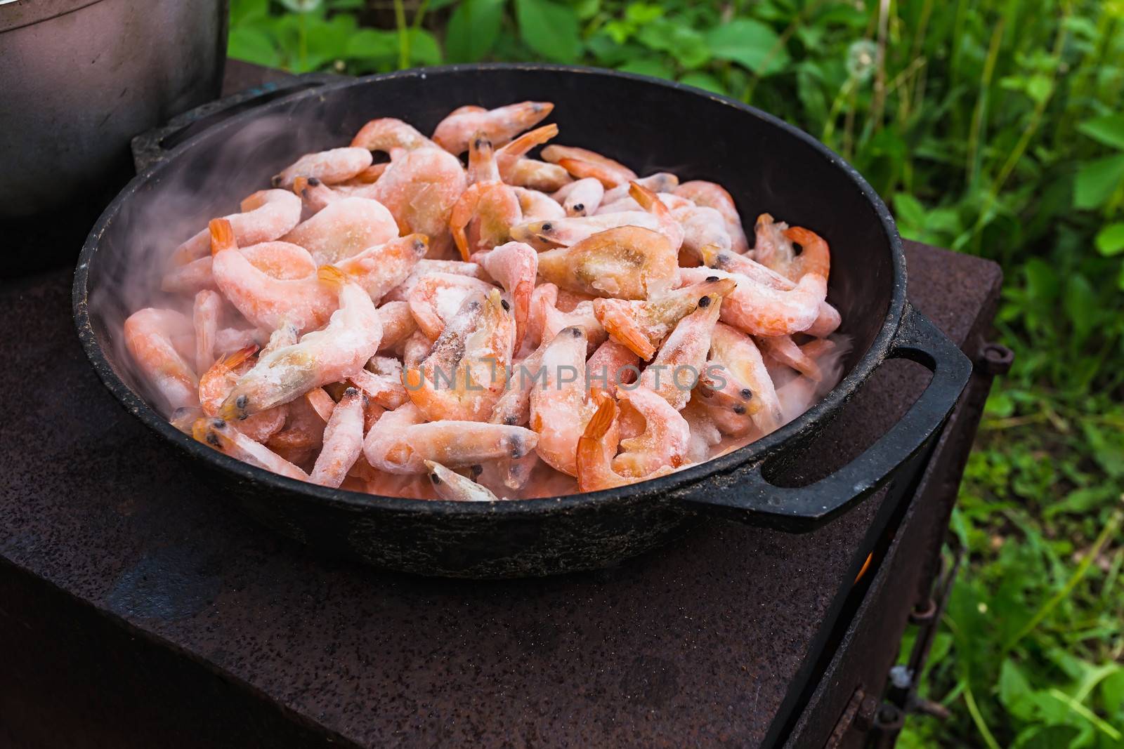 Cooking frozen shrimp in an old frying pan