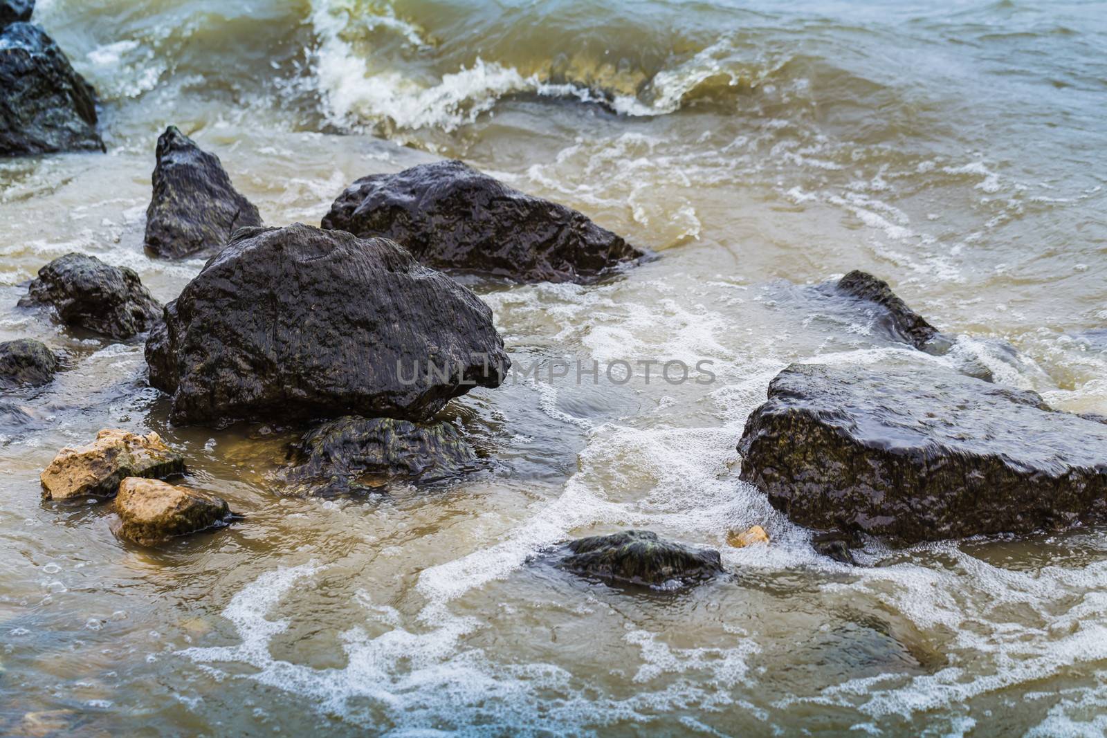 sea surf washes over the coastal stones by oleg_zhukov