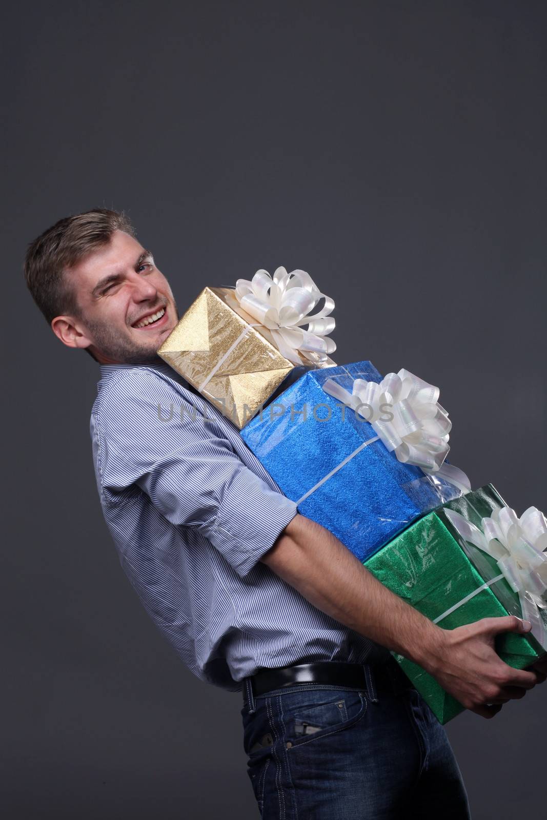 Portrait of young business man with gifts by andersonrise