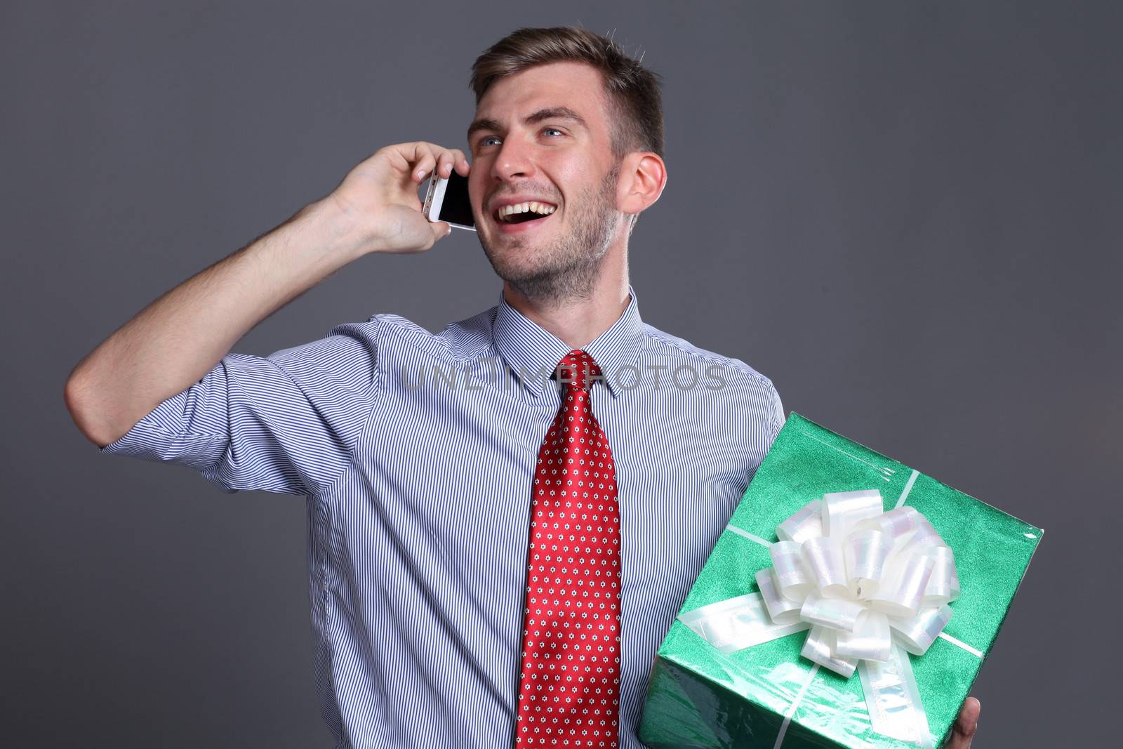 Portrait of young business man with gift