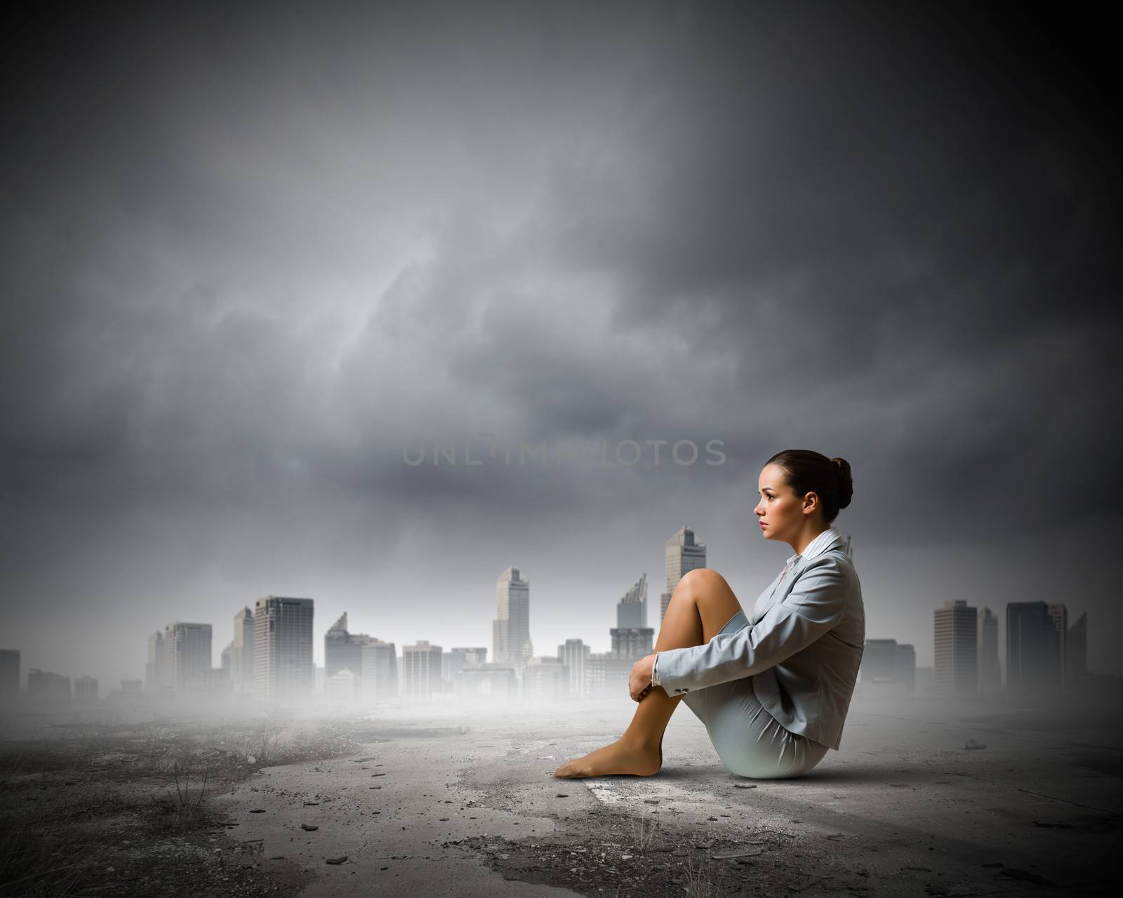 Image of young upset businesswoman sitting alone