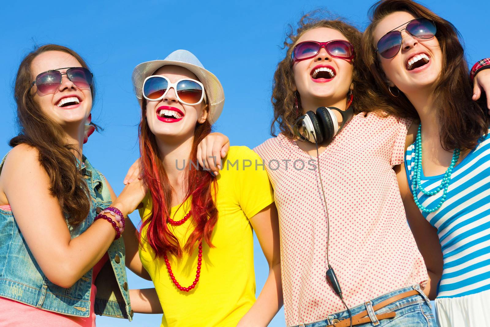 Image of four young attractive girls having fun outdoors