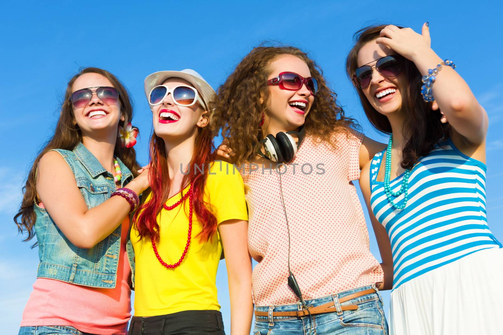 Image of four young attractive girls having fun outdoors
