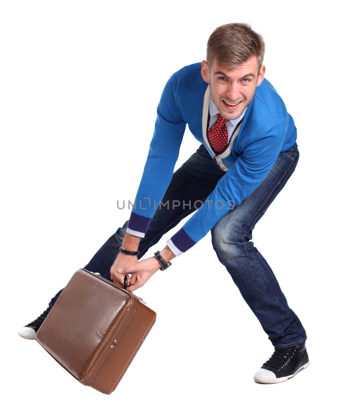 A young man carrying a suitcase