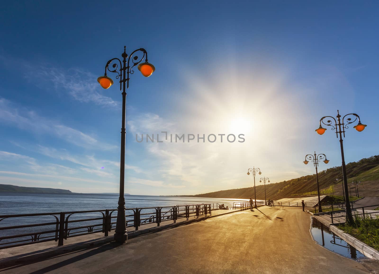 Street lights on the promenade on the shore of the great river