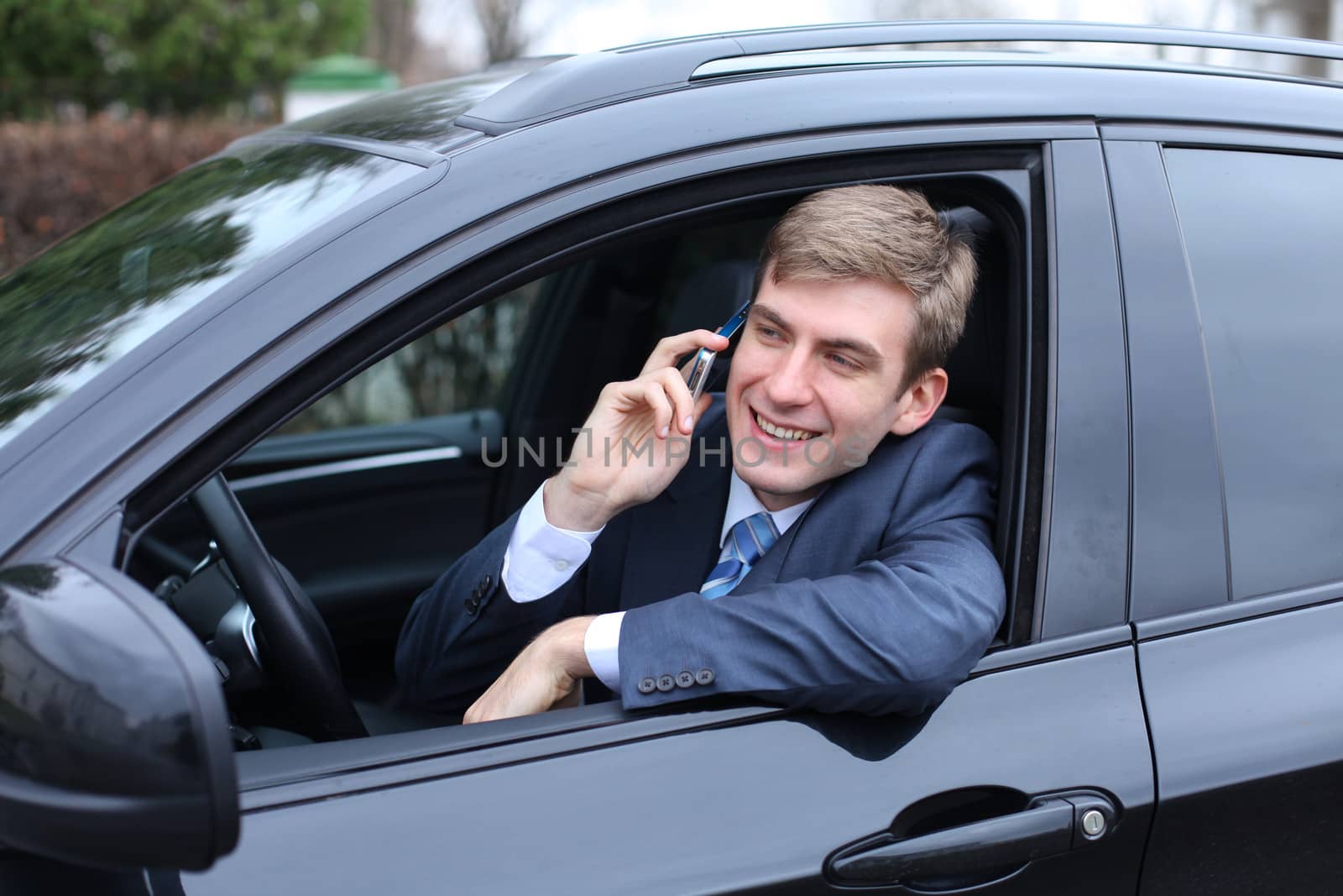 Portrait of young attractive man calling by phone