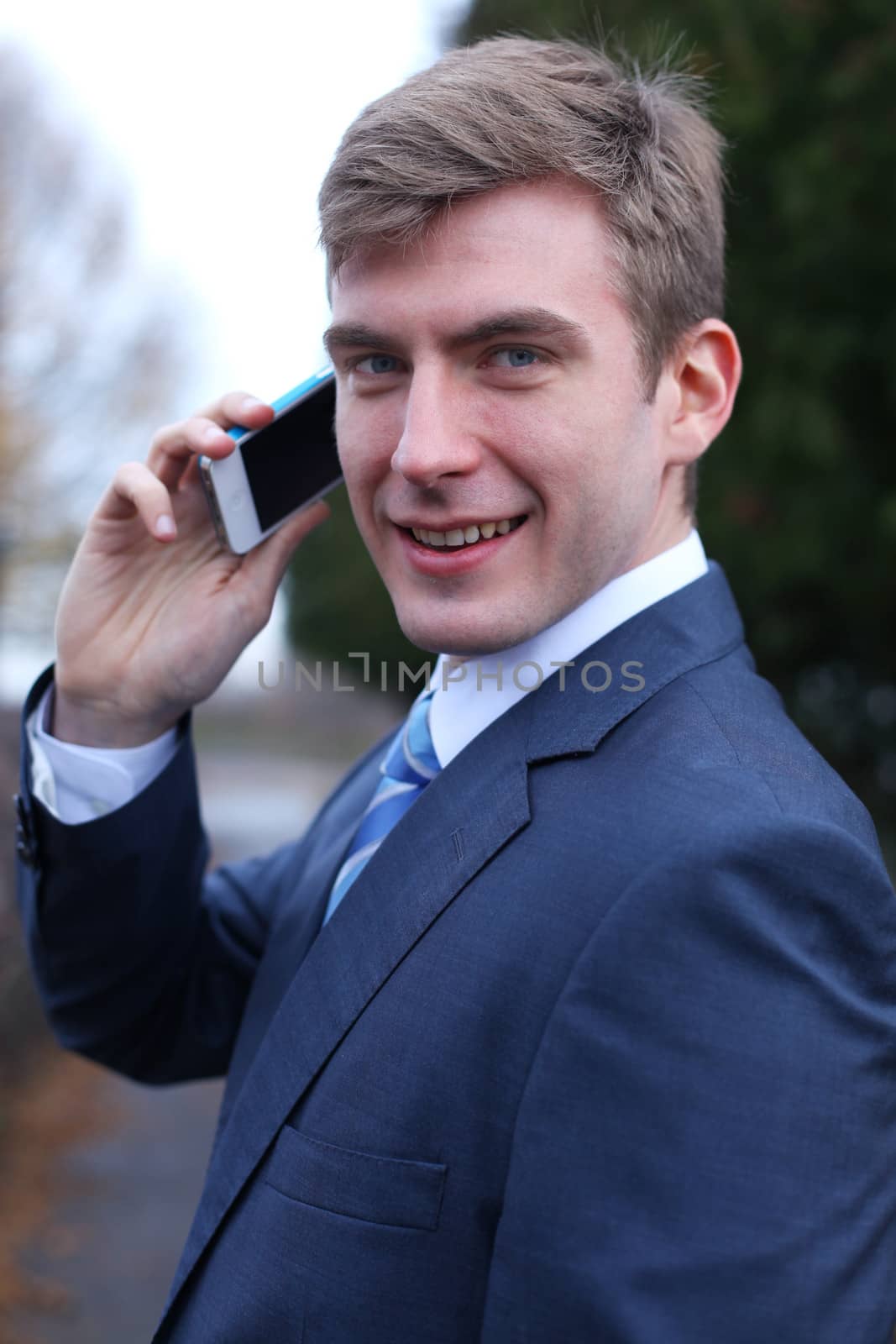 Portrait of young attractive man calling by phone