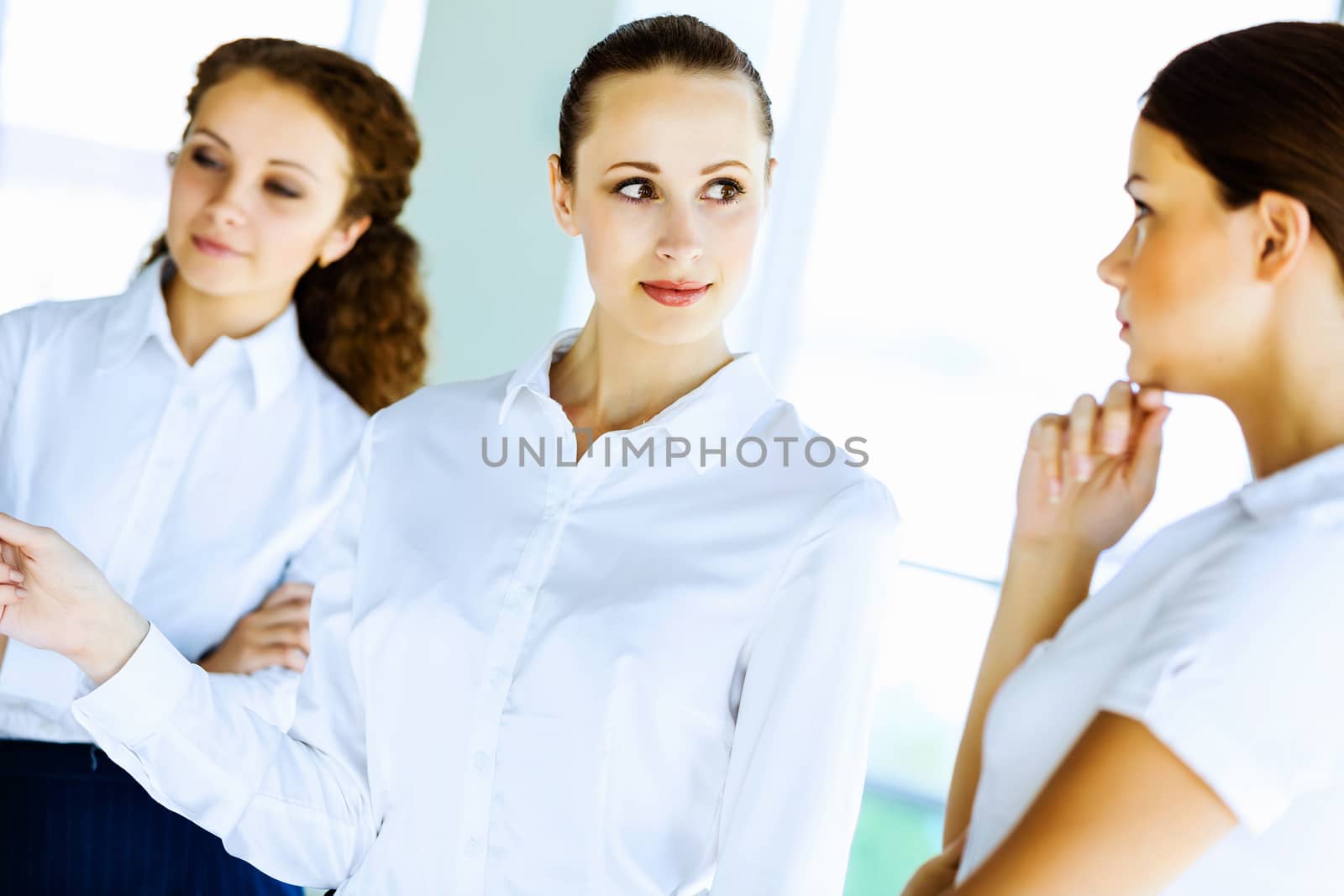 Image of three young businesswomen at meeting