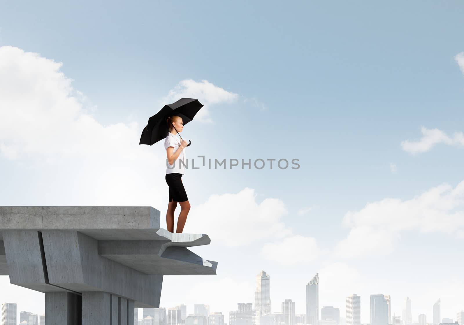 Image of businesswoman standing at the edge of bridge. Risk concept