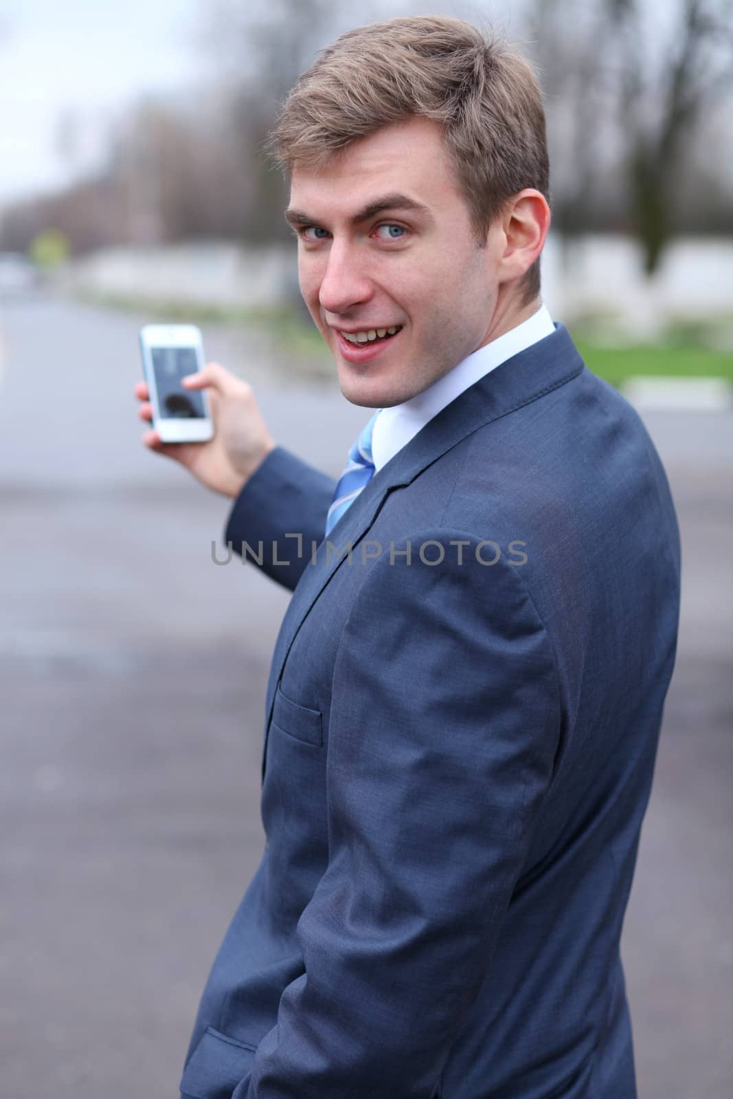 Portrait of young attractive man calling by phone