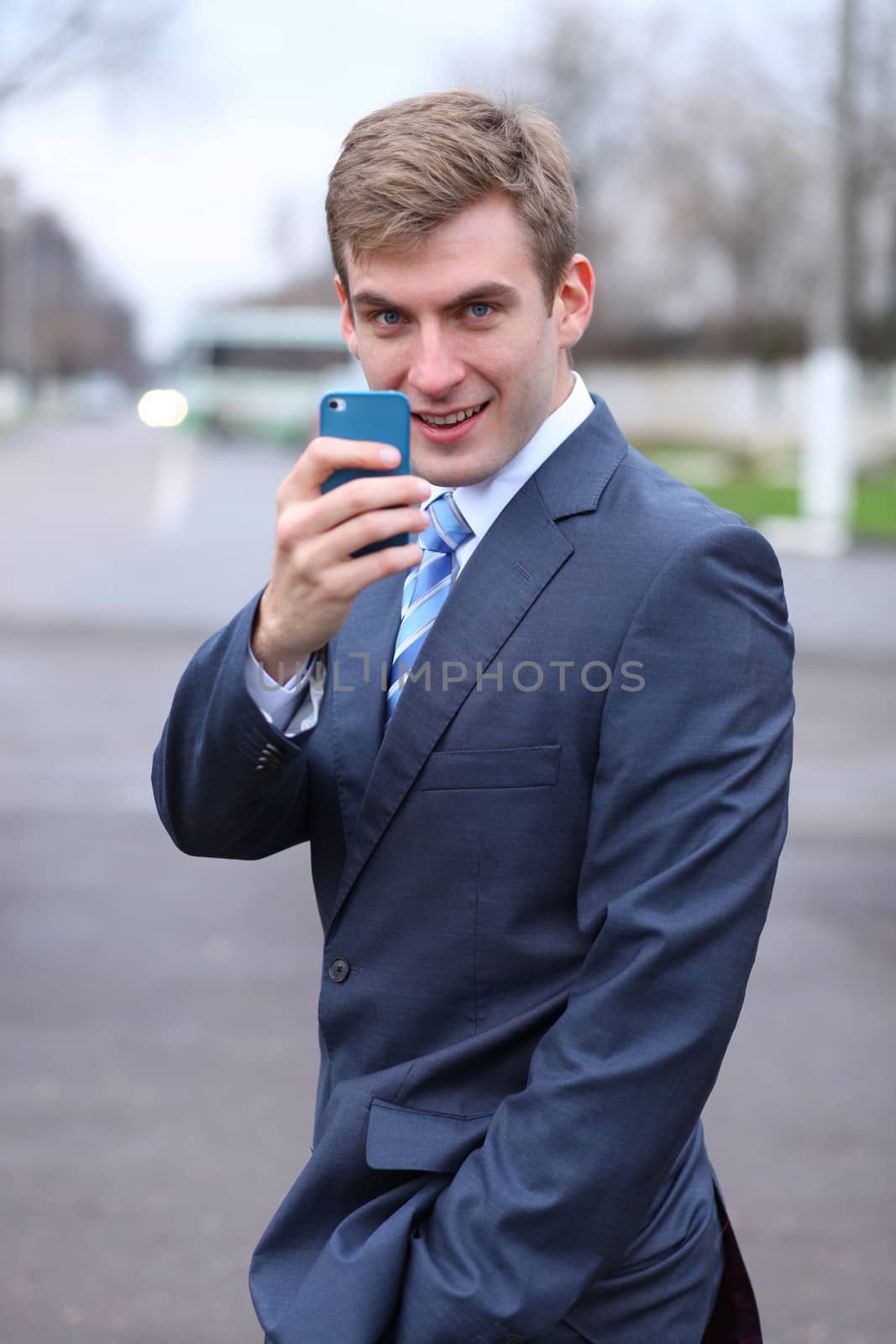 Portrait of young attractive man calling by phone