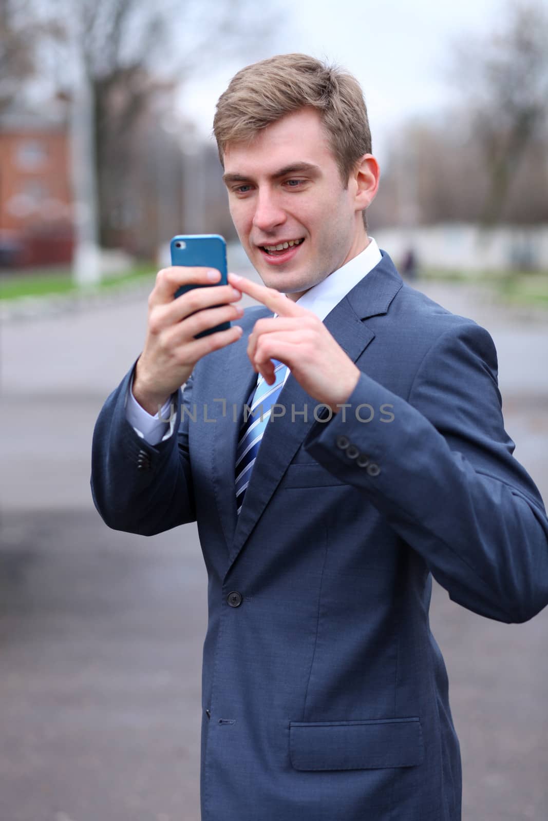 Portrait of young attractive man calling by phone