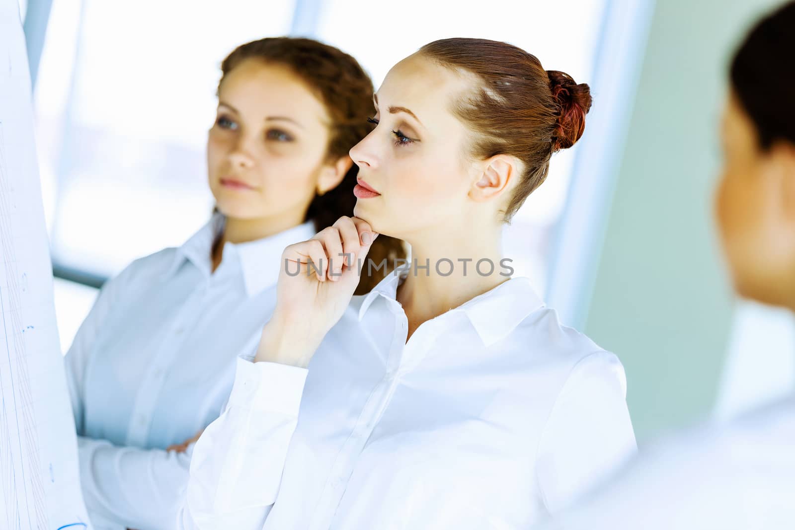 Image of three young businesswomen at meeting