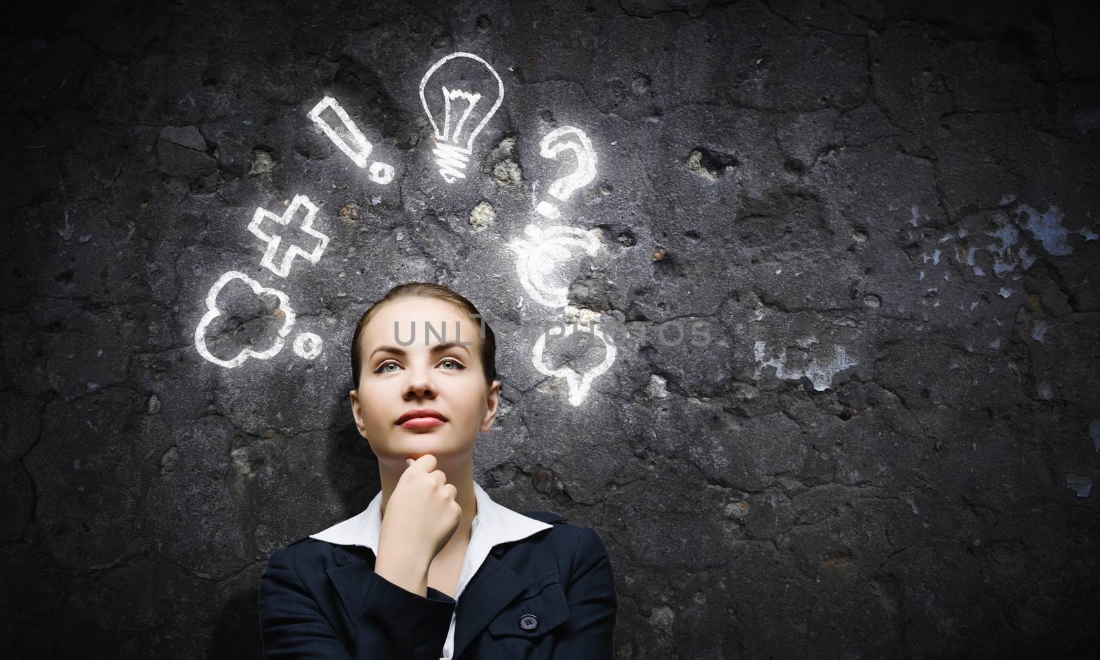 Image of thoughtful businesswoman looking at light bulb