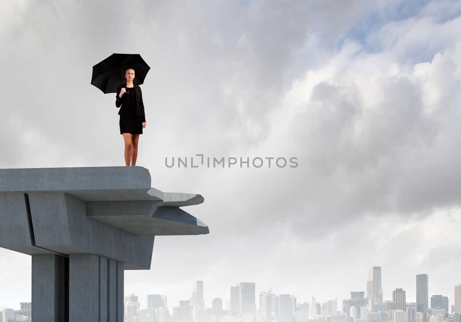 Image of businesswoman standing at the edge of bridge. Risk concept