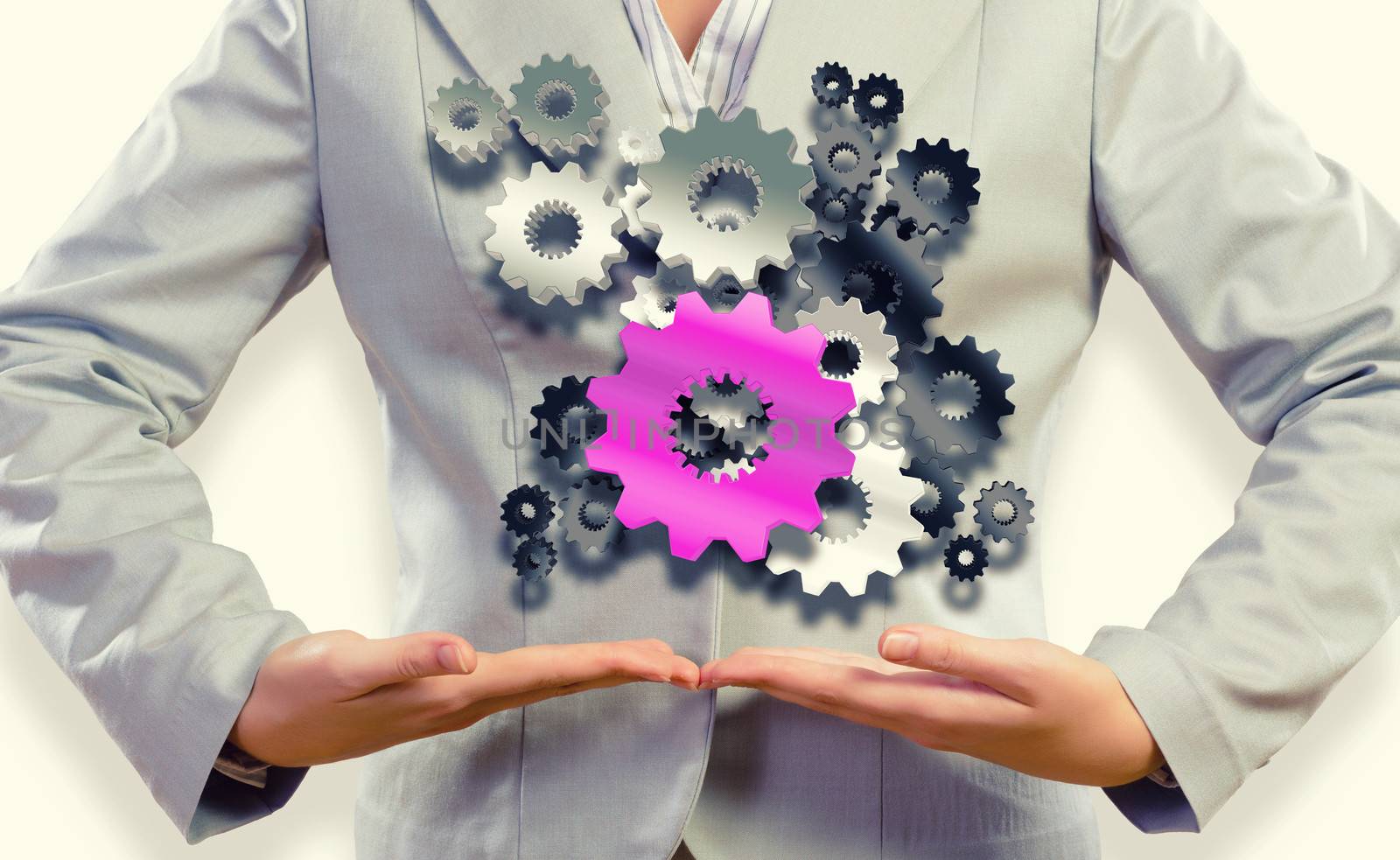 Close up image of businesswoman holding gears in hands