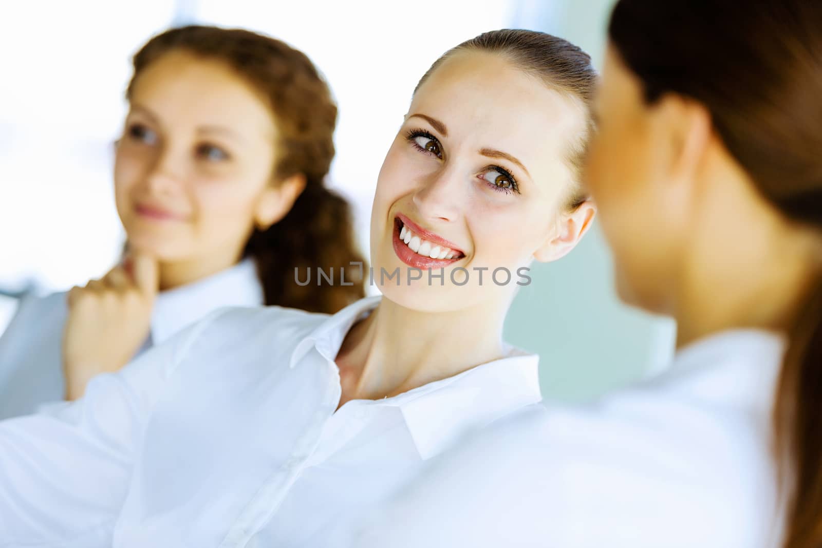 Image of three young businesswomen at meeting