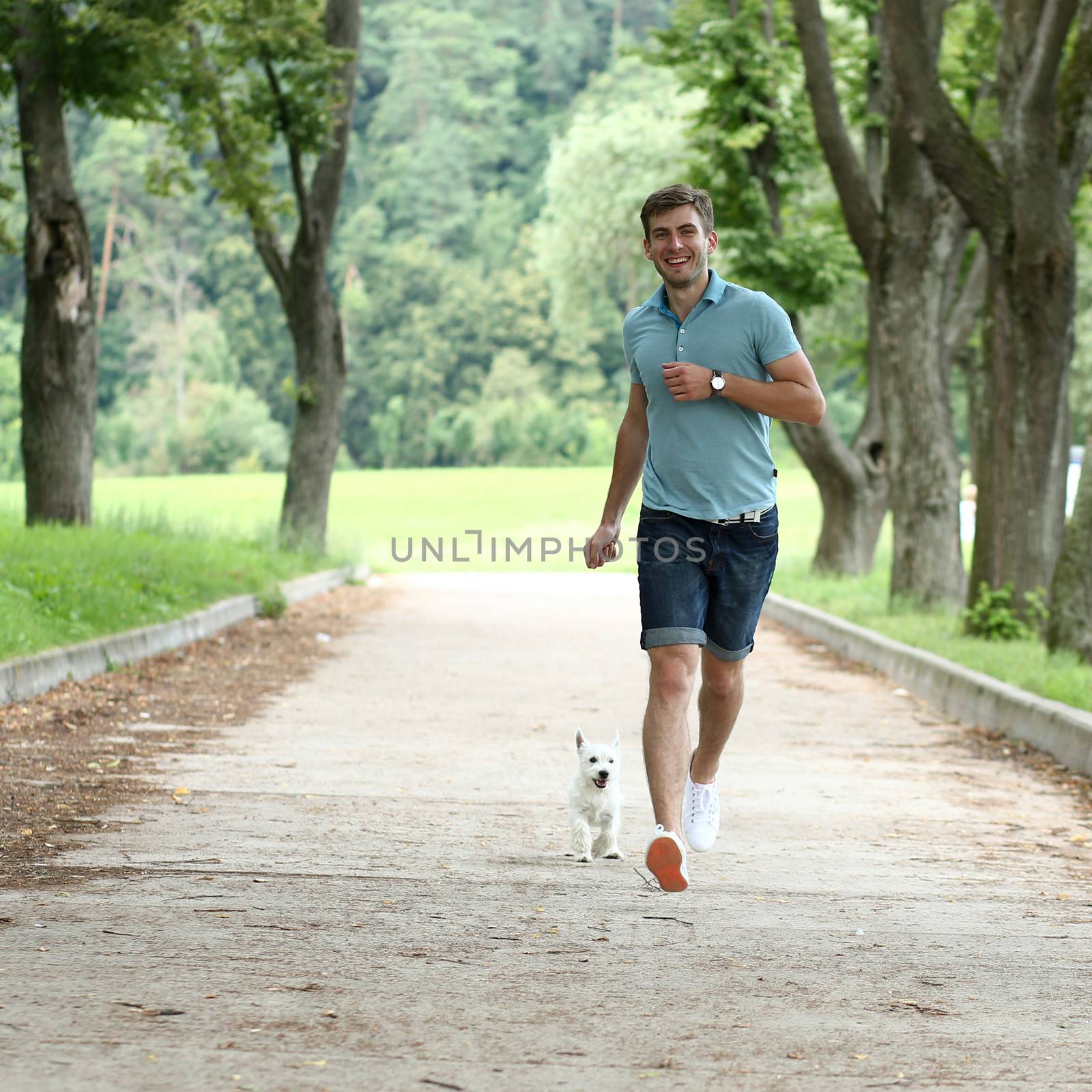 Young man running with your dog by andersonrise