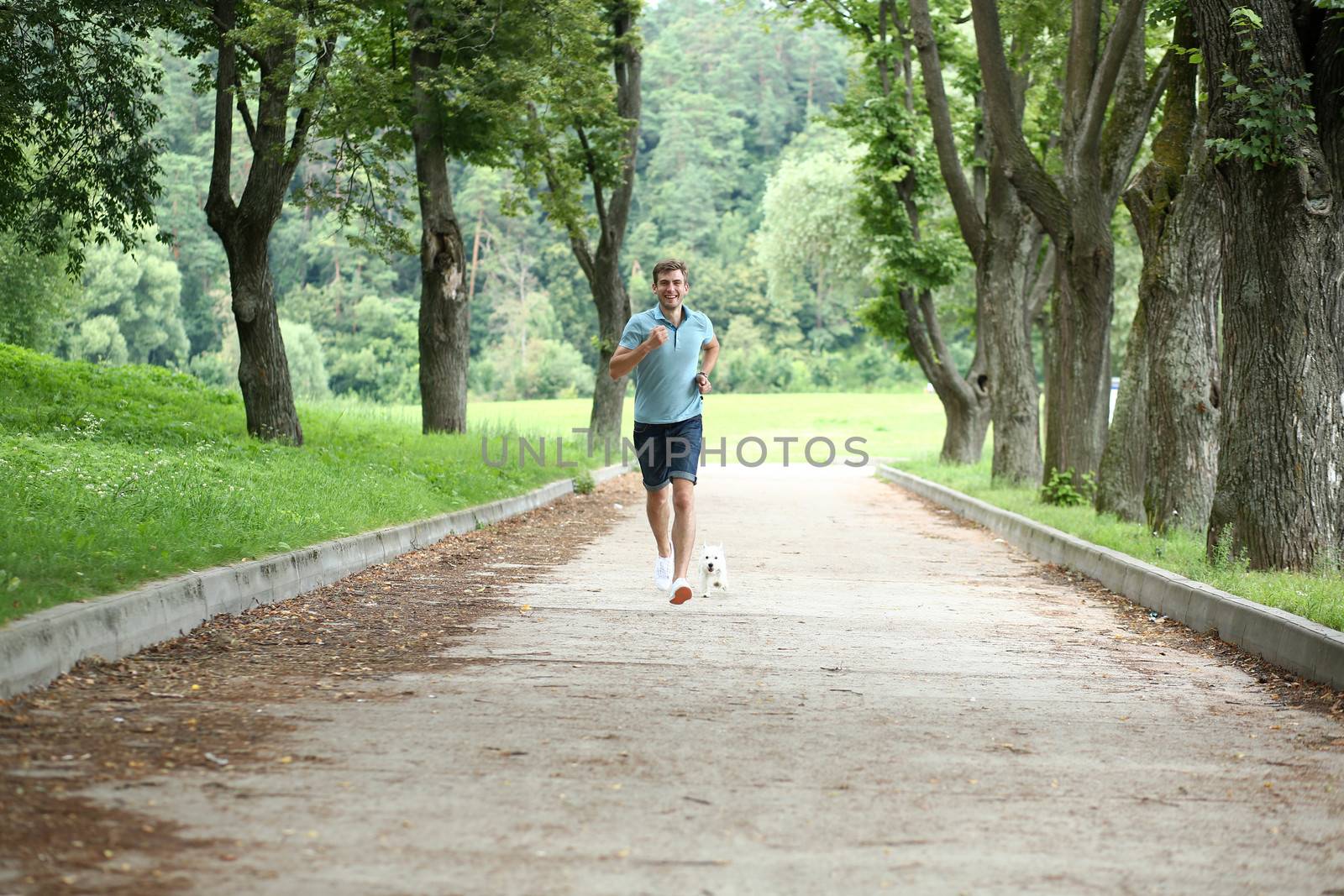 Young man running with your dog by andersonrise