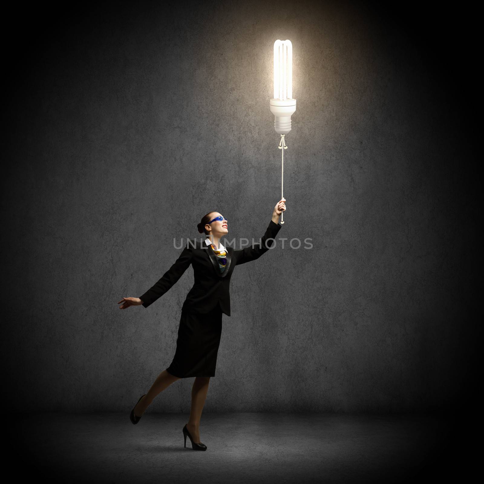 Image of businesswoman holding bulb balloon. idea concept