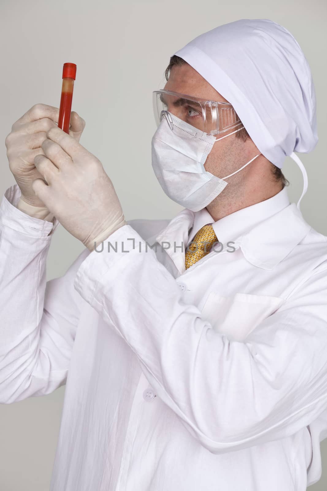 Doctor holding a beaker of blood by andersonrise