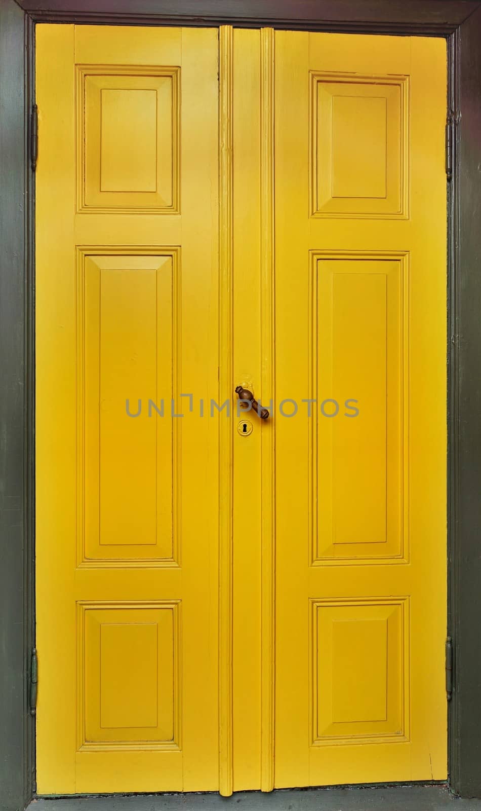 Yellow door with dark green wooden frame